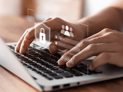 Two hands typing on a laptop keyboard